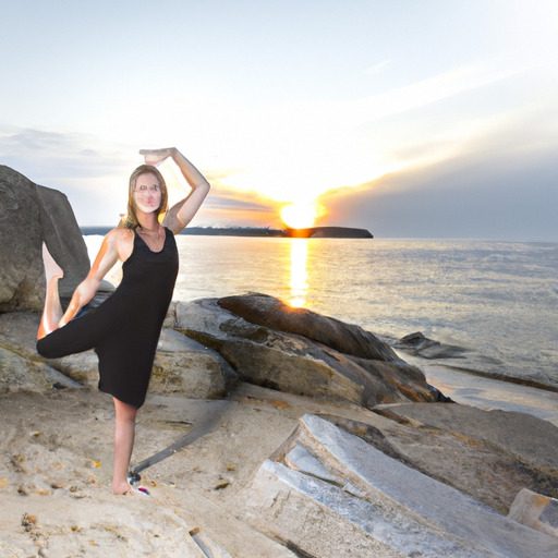 A woman practicing yoga on a beach at sunrise